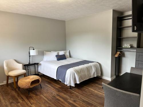 a bedroom with a bed and a table and a chair at North Coast Place in Marquette