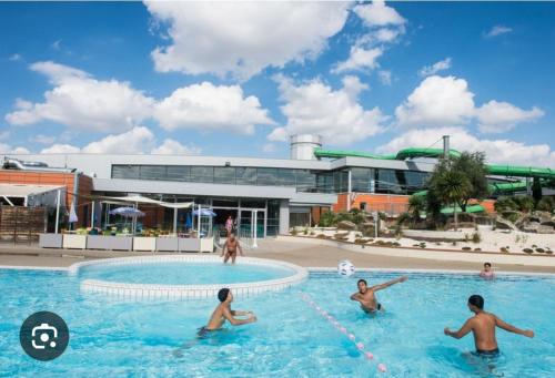 a group of people playing in a swimming pool at *Chez Anissou 2* in Colomiers