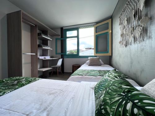 a room with two beds and a window at Parallelo Loft Salento P4 in Salento