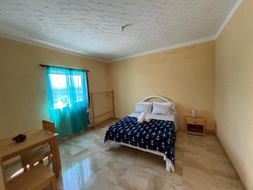 a bedroom with a bed and a window at Casa Tito Montrond in Portela