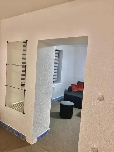 a living room with a couch and a mirror at Apart Cobras Jajce in Jajce
