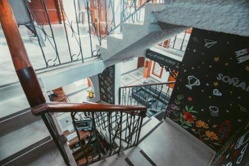 an overhead view of a stairway with a bench and a stair case at Hostal Pura Vida la 70 in Medellín