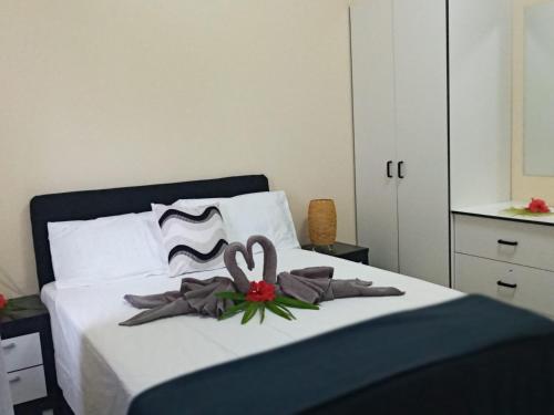 a bedroom with a bed with two swans on it at Singhs elite apartment in Nadi