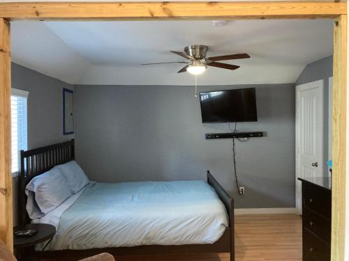 a bedroom with a bed and a ceiling fan at The GREEN Tiny House in Houston