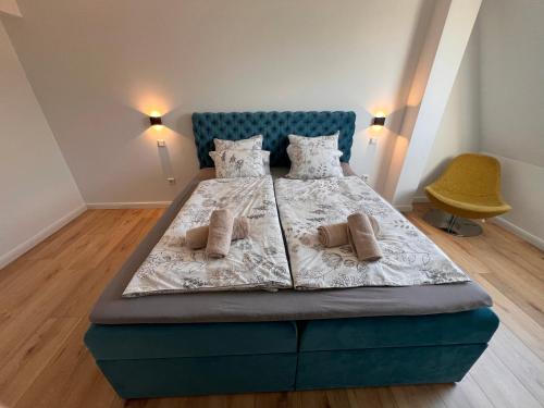 sypialnia z niebieskim łóżkiem z 2 poduszkami w obiekcie Kurpark Oase w mieście Bad Lippspringe
