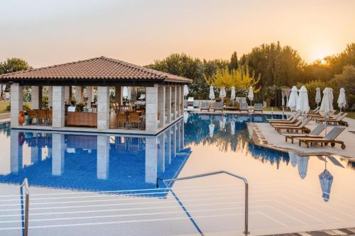 a pool at a hotel with a gazebo at The Romanos, a Luxury Collection Resort, Costa Navarino in Romanós