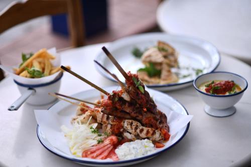 a table with three plates of food on it at The Romanos, a Luxury Collection Resort, Costa Navarino in Romanós