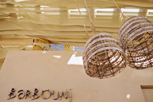 two lights hanging from the ceiling of a store at The Romanos, a Luxury Collection Resort, Costa Navarino in Romanós