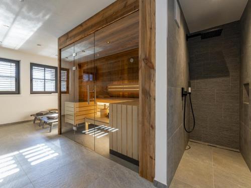 a bathroom with a shower and a glass wall at Haus am Hang in Saalbach-Hinterglemm