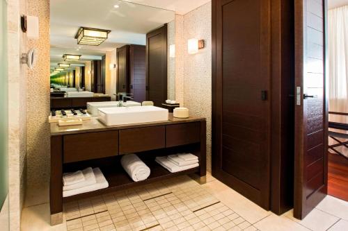 a bathroom with a sink and a mirror at The Romanos, a Luxury Collection Resort, Costa Navarino in Romanós