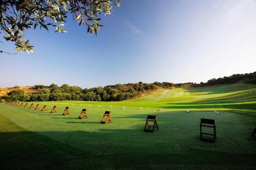 a group of chairs on a golf course at The Romanos, a Luxury Collection Resort, Costa Navarino in Romanós
