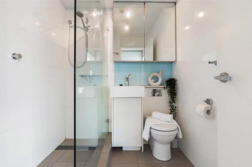 a bathroom with a toilet and a glass shower at Harbourside #53 in Sydney
