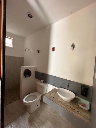 a bathroom with a toilet and a sink at Casa Coral Pueblito - Self Check In in Mahahual