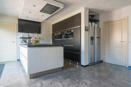 a kitchen with a white counter and a refrigerator at House Xxl Free Parking 3 Bedrooms in Tilburg