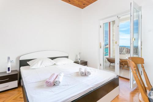 a bedroom with a bed with two towels on it at Apartments by the sea Tucepi, Makarska - 22384 in Tučepi