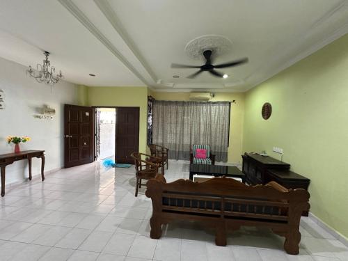 a living room with a couch and a ceiling fan at Casa Lily Residence IM8 in Kuantan