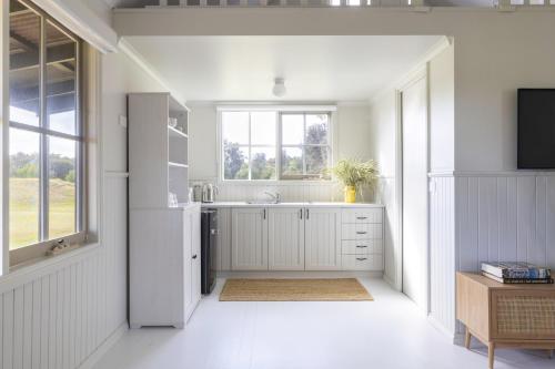 a white kitchen with a sink and a window at Red Rocks Golf & Accommodation - Phillip Island in Cowes