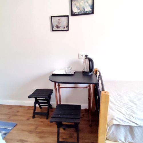 a table with two chairs and a tea kettle on it at 9 Doors in Tbilisi City