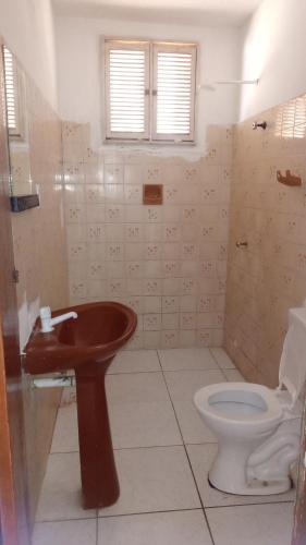 a bathroom with a sink and a toilet at Casa Beira Mar - Praia Icaraí - CE in Caucaia