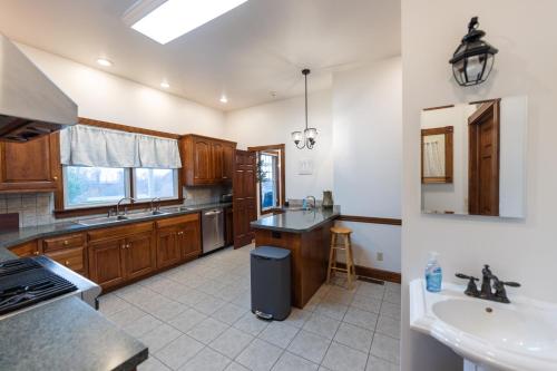 a large kitchen with wooden cabinets and a sink at Hillside Villa Ohio in Millersburg