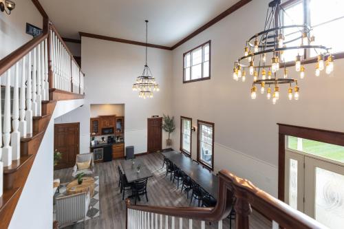 an open living room with a staircase and chandelier at Hillside Villa Ohio in Millersburg