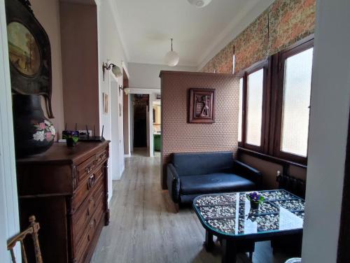a living room with a blue couch and a table at 9 Doors in Tbilisi City