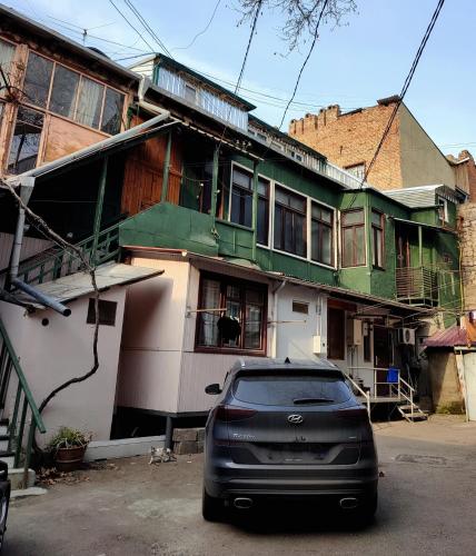 a black car parked in front of a house at 9 Doors in Tbilisi City