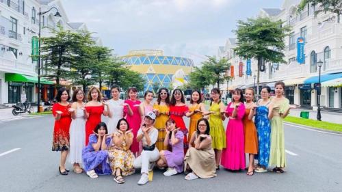 a group of women posing for a picture in the street at Beach Hotel Grand World (La La Homestay) in Phu Quoc