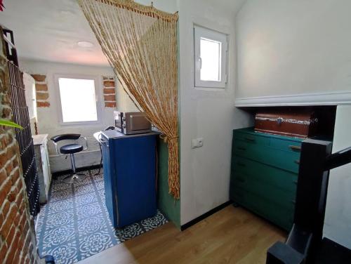a room with a blue dresser and a window at 9 Doors in Tbilisi City