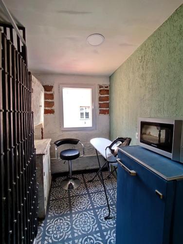 a room with a desk and a chair and a window at 9 Doors in Tbilisi City