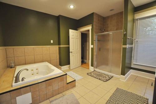 a large bathroom with a tub and a shower at The Troubadour- Location Location in Columbus