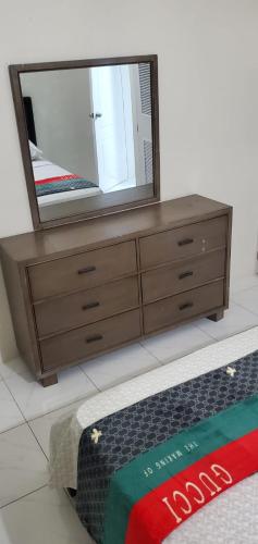 a dresser with a mirror on top of it at Finest Accommodation Phoenix Park Phase 4 Lot # 1348 Portmore St Catherine in Portmore