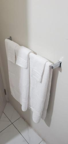 a group of towels hanging on a towel rack in a bathroom at Finest Accommodation Phoenix Park Phase 4 Lot # 1348 Portmore St Catherine in Portmore