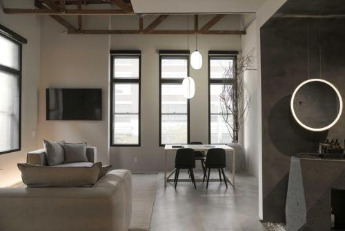 a living room with a couch and a table at kodō hotel - Heart of LA Arts District in Los Angeles