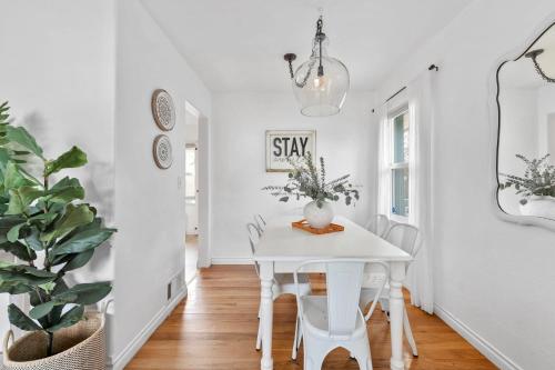 a white dining room with a white table and chairs at Sunlit Scandi Haven - Walk to Whitworth U & Shops in Nine Mile Falls