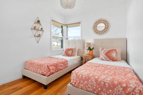 a bedroom with two beds and a window at Sunlit Scandi Haven - Walk to Whitworth U & Shops in Nine Mile Falls