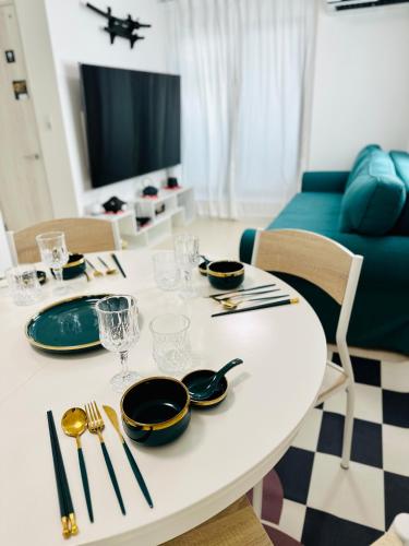 a white table with plates and utensils on it at Colorful House SKY TREE in Tokyo