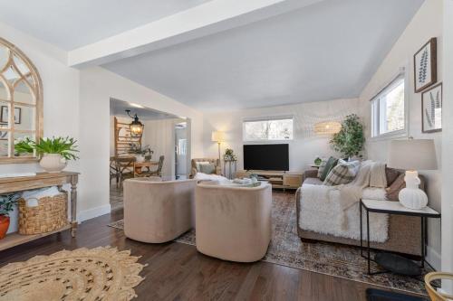 a living room with a couch and a tv at Light Bright Stylish PRIVATE Home - Whitworth in Spokane
