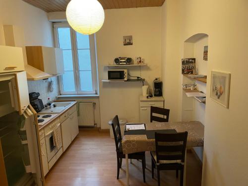 a kitchen with a table and chairs and a dining room at Holländers Appartement in Bruchsal