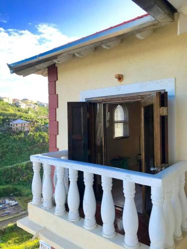 a balcony with a white railing on a house at 702 w/ a view at Princess Heights in Dawn Beach