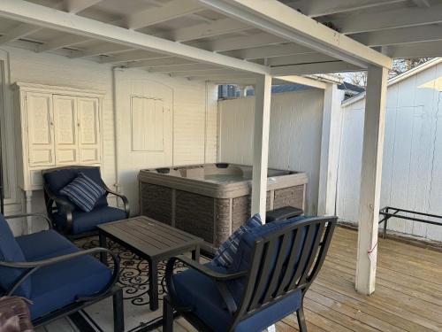 a patio with chairs and a table and a grill at Beautiful Bungalow on Main in Madison