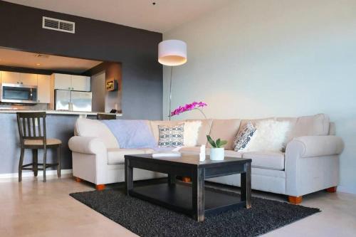 a living room with a white couch and a table at 702 w/ a view at Princess Heights in Dawn Beach