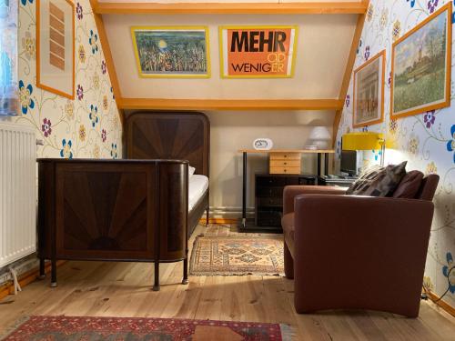 a living room with a couch and a tv at Gudrun 5 pers Equipped house with sauna. Dogs are welcome! in Anjum