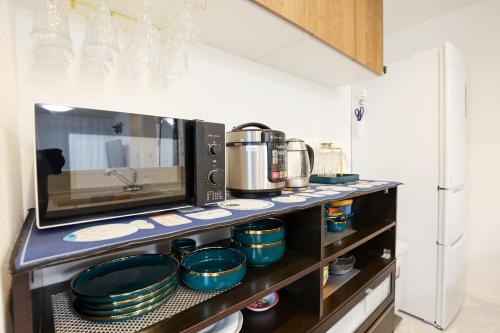 a kitchen with a counter with pots and pans at Colorful House SKY TREE in Tokyo