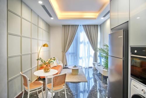 a living room with a table and a refrigerator at Royce Residence KLCC by Cobnb in Kuala Lumpur
