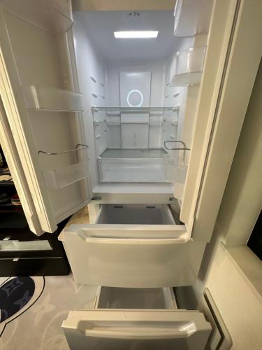 an empty refrigerator with its door open in a kitchen at Colorful House SKY TREE in Tokyo