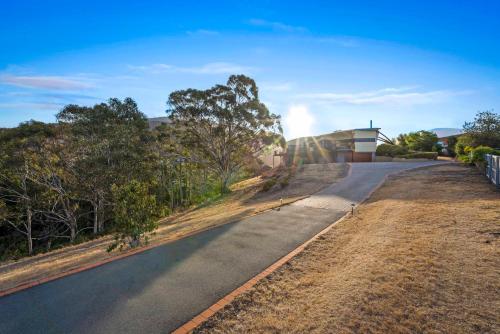 an empty road in front of a house at Tree Top Views - Magnificent 4 Bedroom House - 3 Minutes to MONA in Rosetta