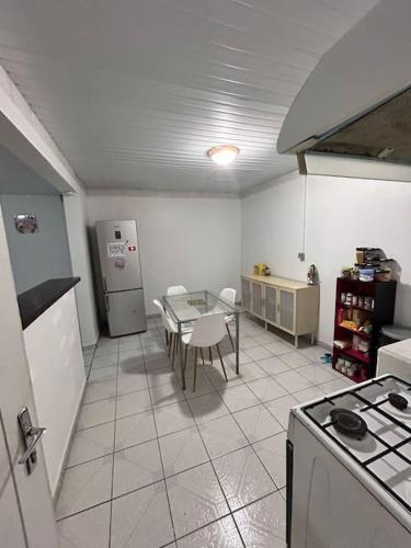 a kitchen with a table and a tableasteryasteryasteryasteryasteryasteryasteryastery at L'escale de Paramana Ouest in Matoury