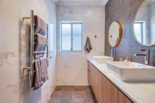 a bathroom with a sink and a mirror at Como Sora - A Breezy Tranquil Oasis on the Coast in Perth