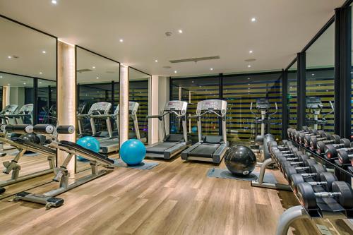a gym with several treadmills and exercise machines at Satya Da Nang Hotel Han Market in Da Nang